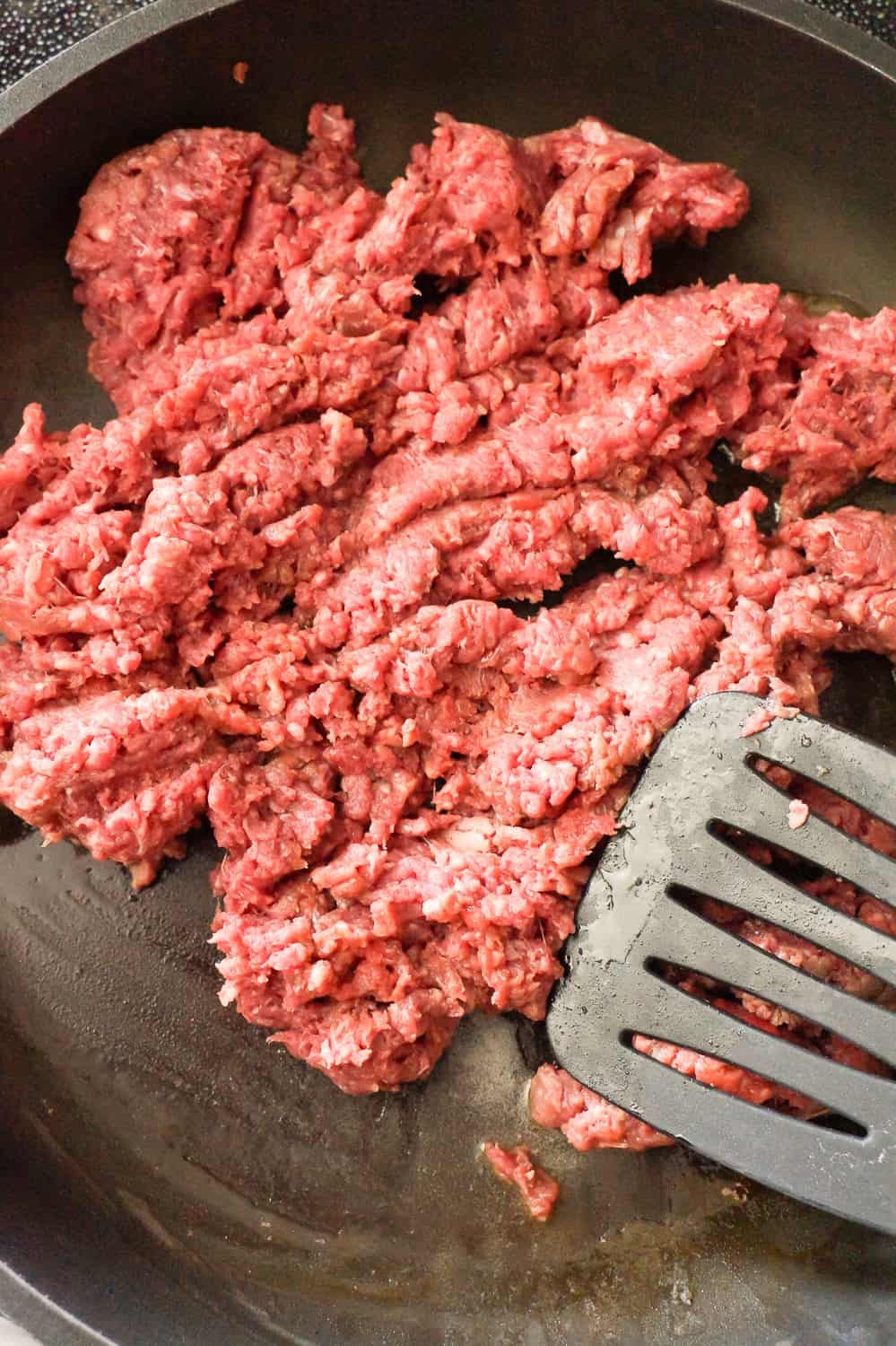 raw ground beef in a frying pan