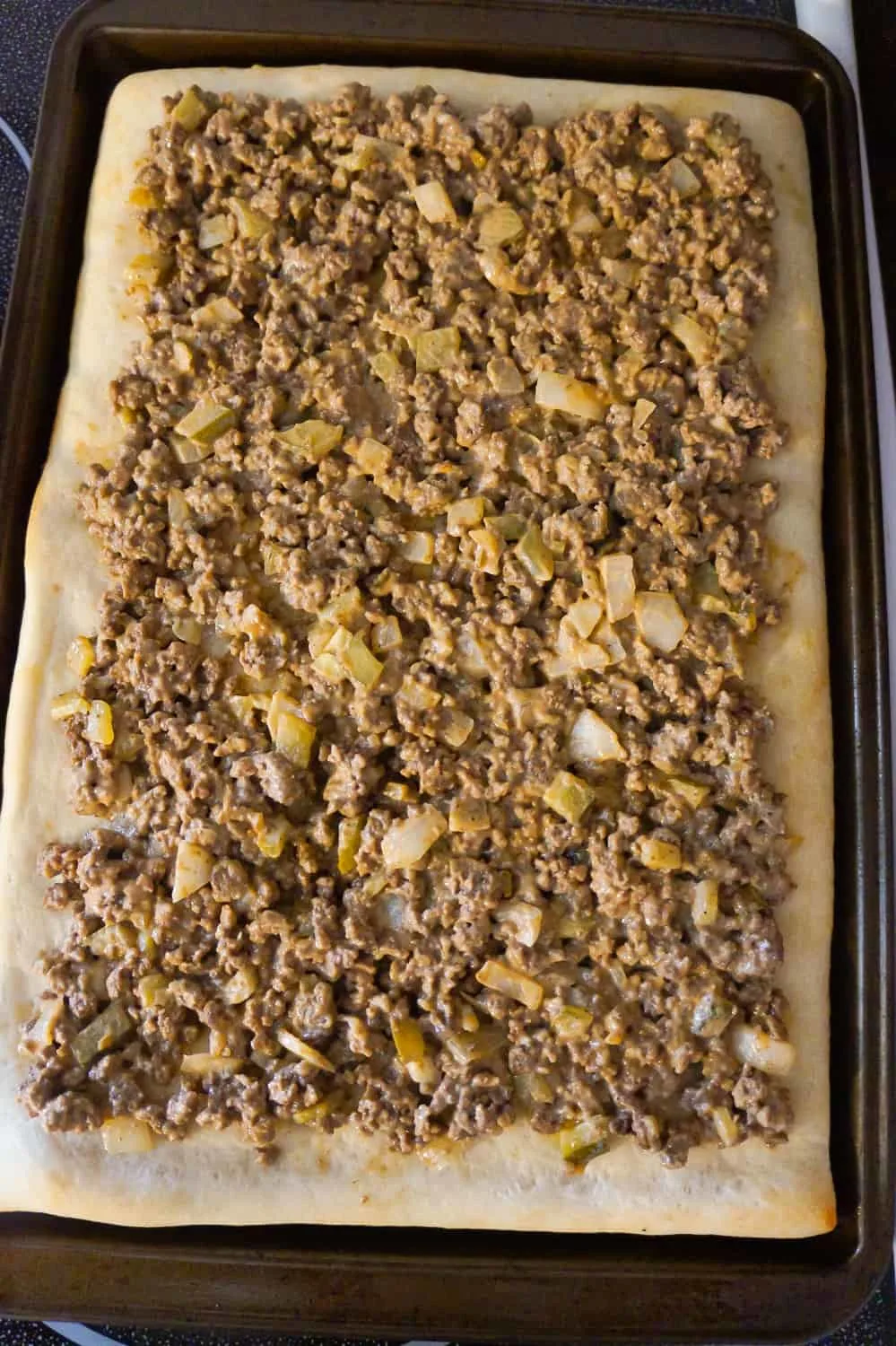 ground beef mixture on top of pizza crust 
