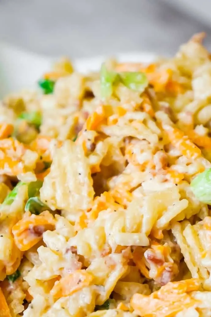 Cheddar Bacon Ranch Pasta Salad is a quick and easy cold side dish recipe perfect for summer. This creamy pasta salad is loaded with shredded cheddar cheese, bacon, green onions and crumbled potato chips.