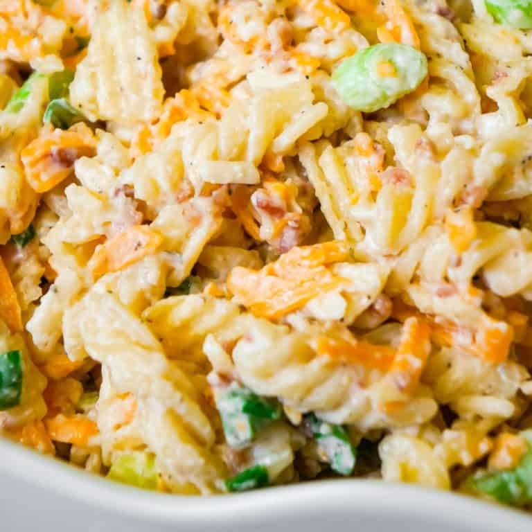 Cheddar Bacon Ranch Pasta Salad is a quick and easy cold side dish recipe perfect for summer. This creamy pasta salad is loaded with shredded cheddar cheese, bacon, green onions and crumbled potato chips.