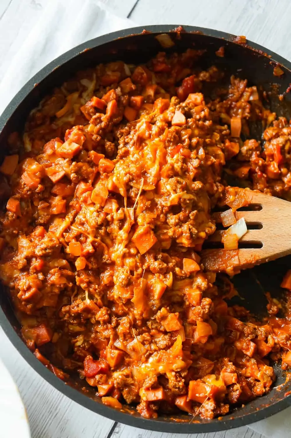 Chili Cheese Dog Sloppy Joes are an easy ground beef dinner recipe perfect for weeknights. These homemade sloppy joes are loaded with chopped wieners, shredded cheese, and onions all tossed in a chili sauce with a bit of a kick.