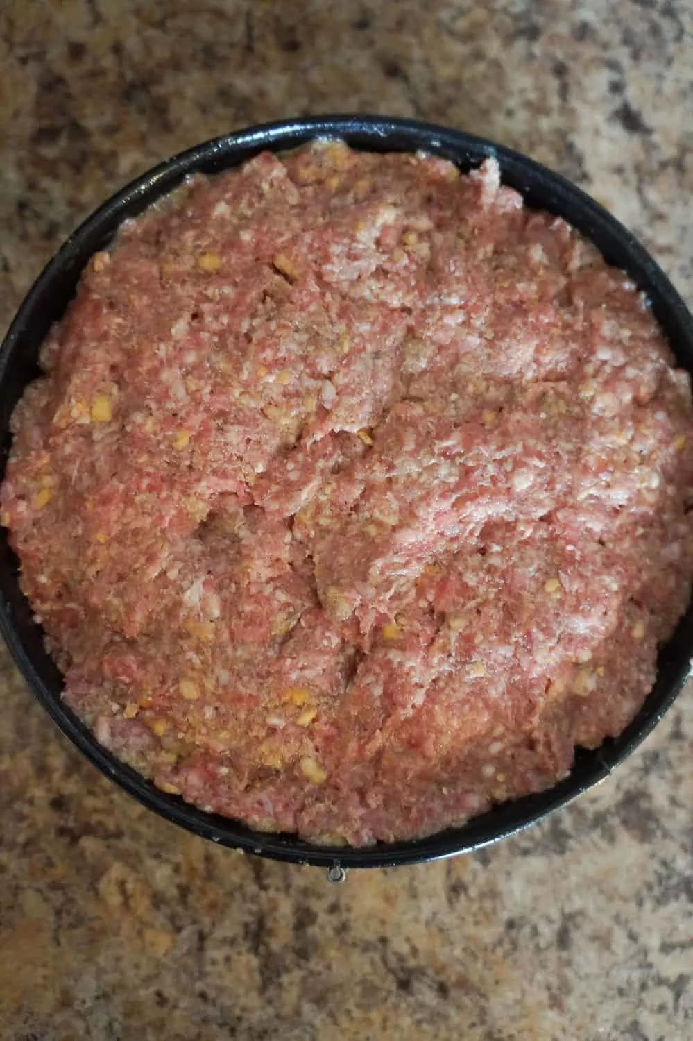 raw meatloaf in a spring form pan