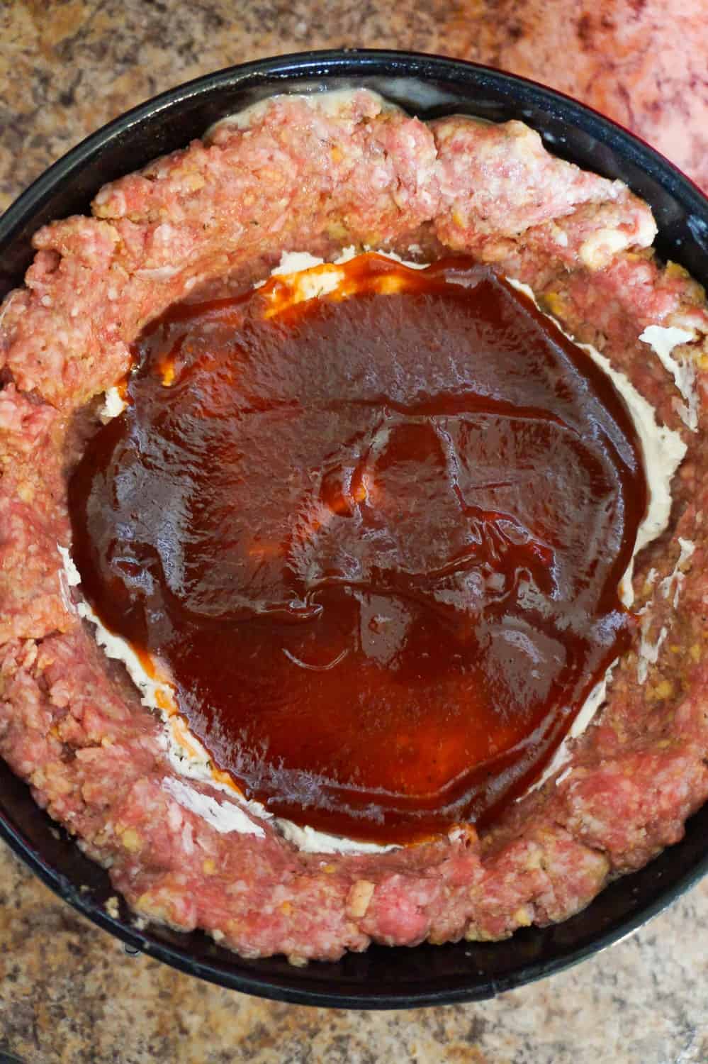 BBQ sauce inside of raw meatloaf