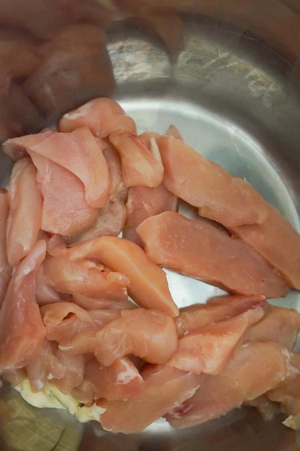 raw chicken breast strips in an Instant Pot