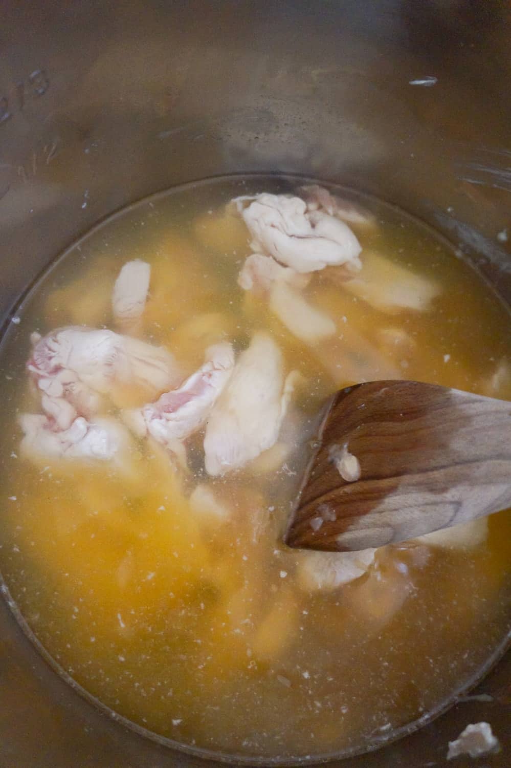 chicken breast strips in chicken broth in an Instant Pot