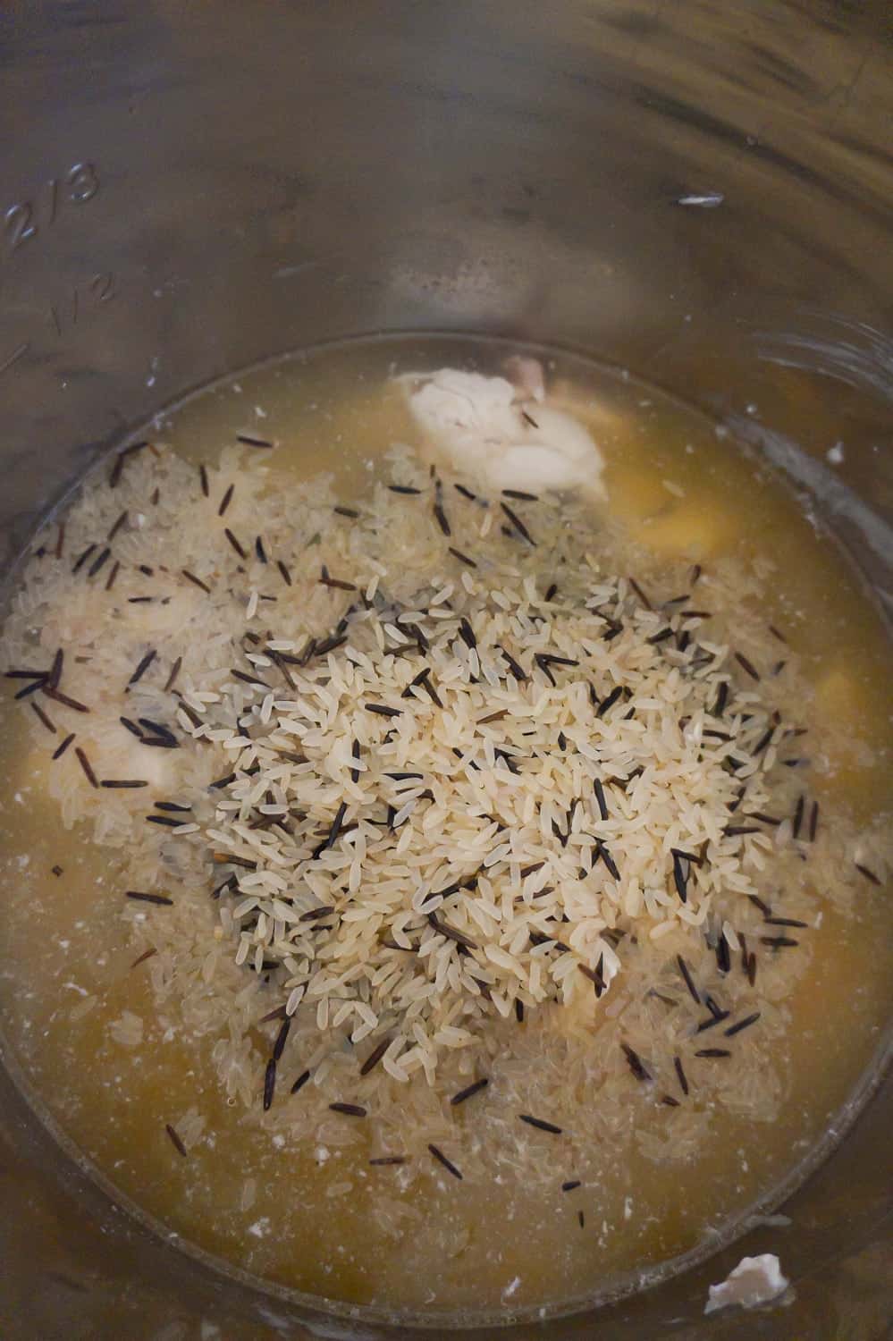 long grain and wild rice in chicken broth in an Instant pot