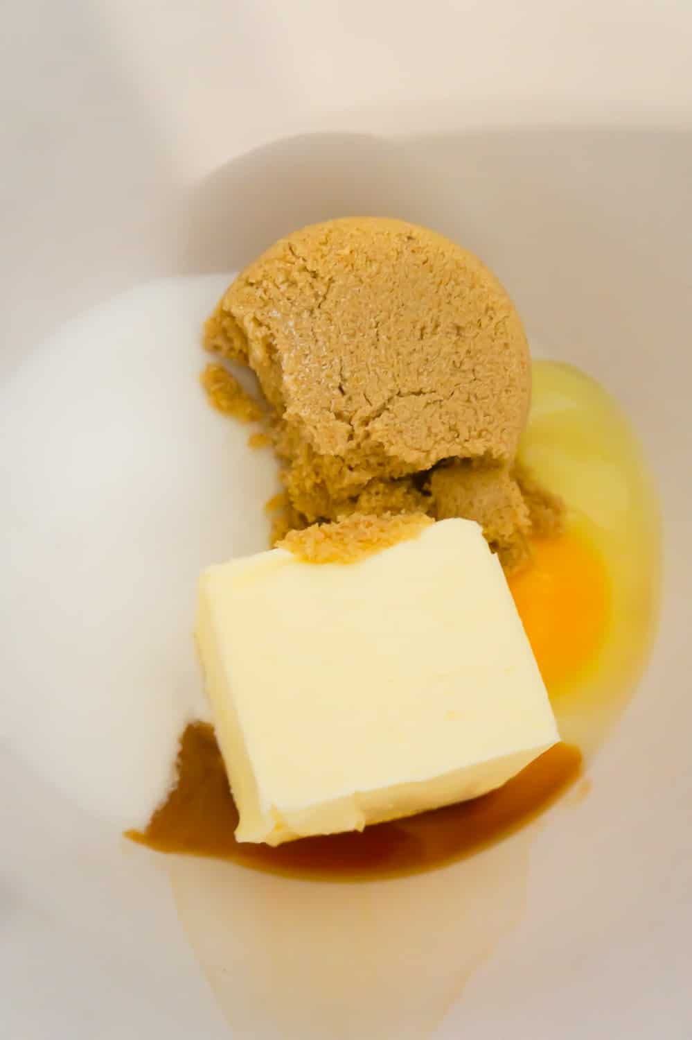 light brown sugar, granulated sugar, butter, an egg and vanilla extract in a mixing bowl