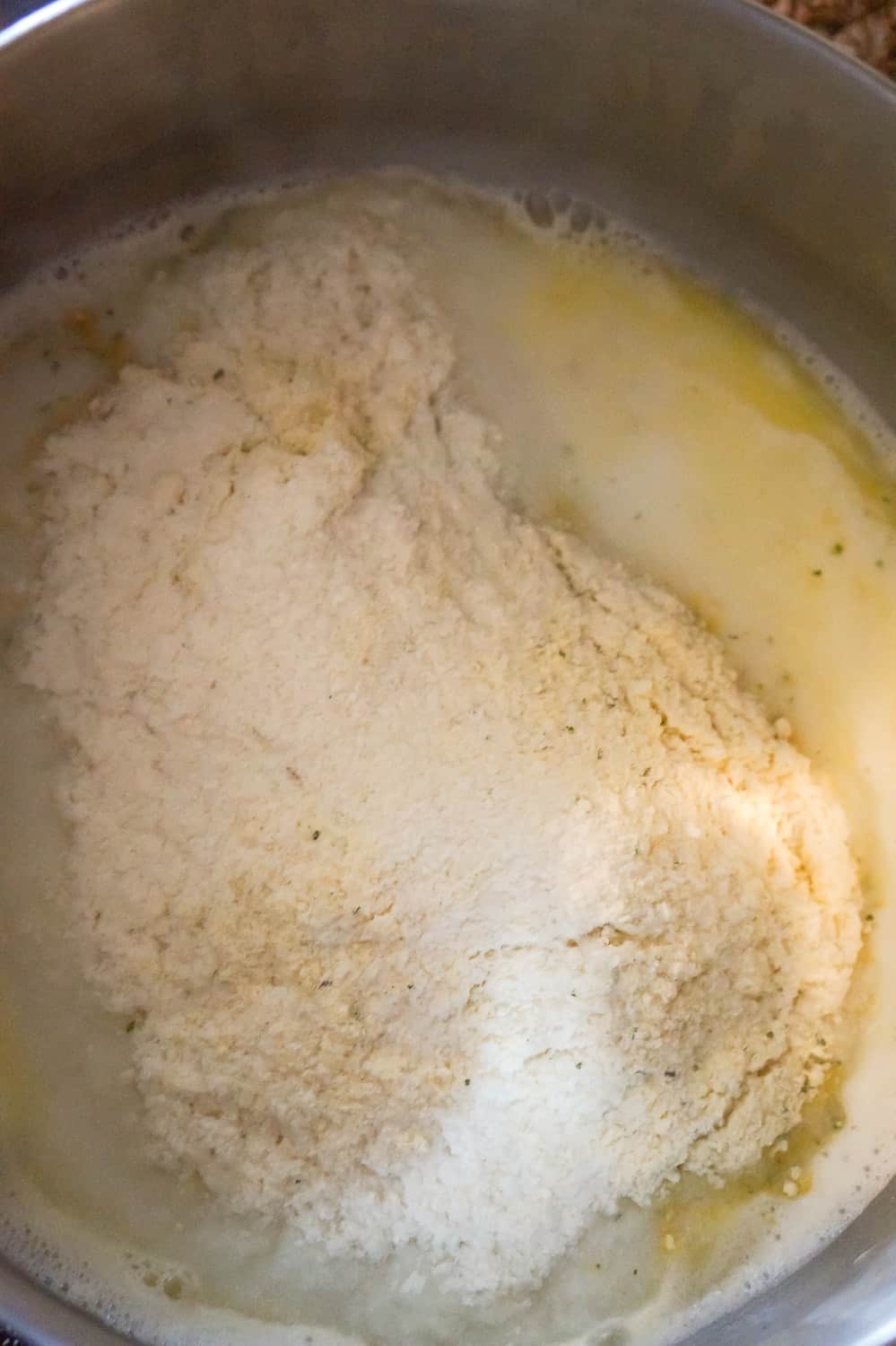instant mashed potato powder on top of liquid in a pot