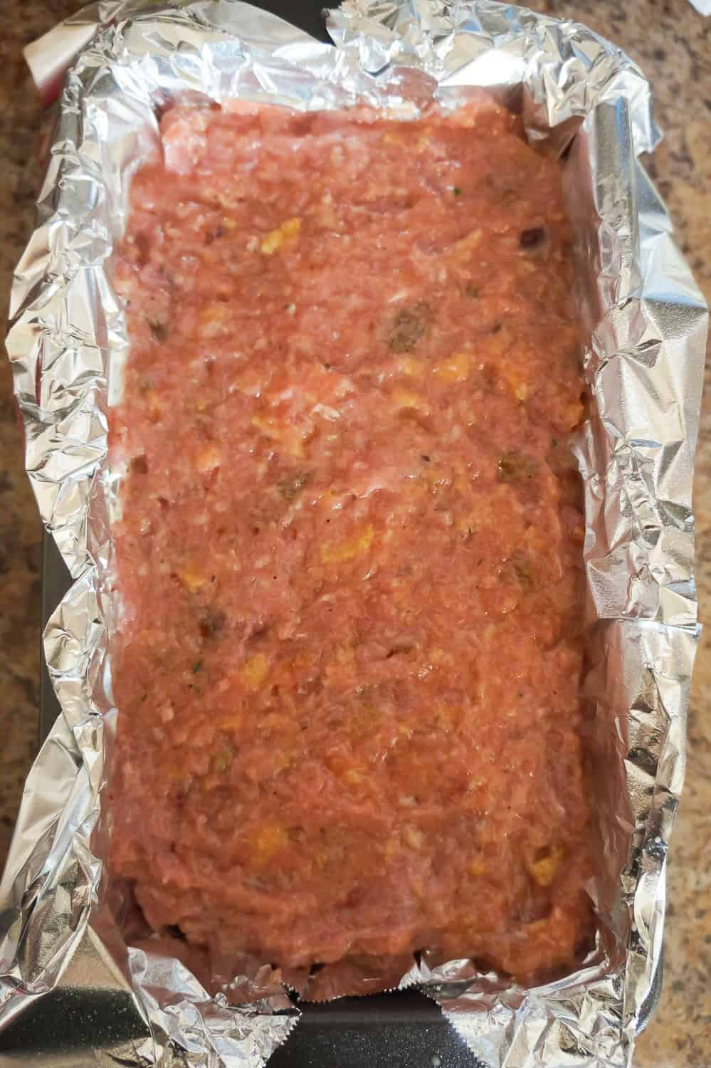 ground turkey meatloaf mixture in a loaf pan before baking