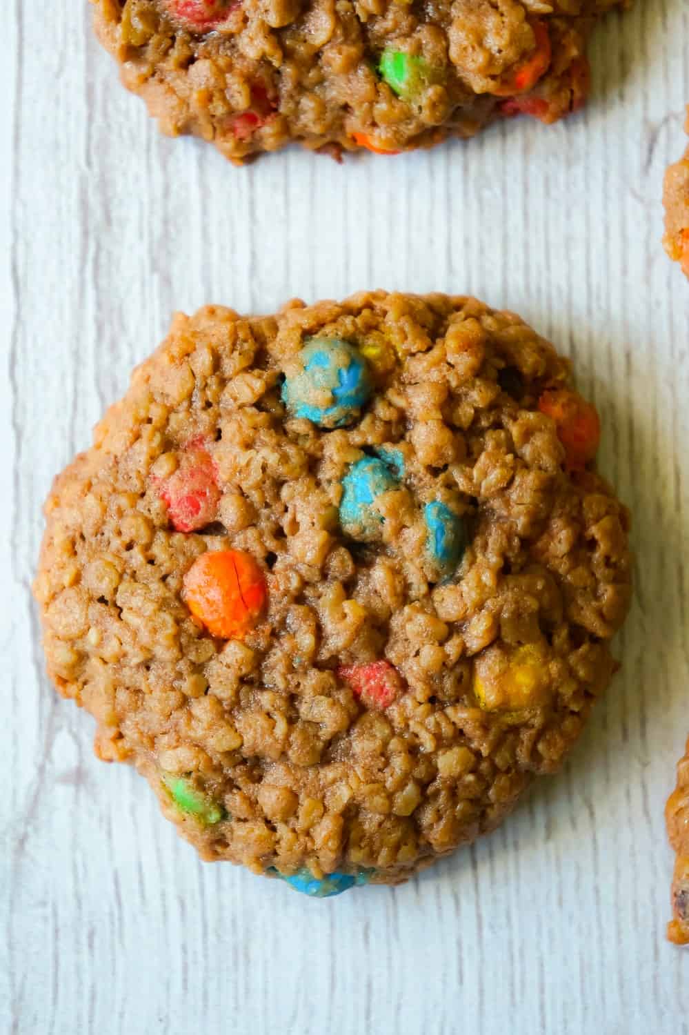 Chocolate Monster Cookies are an easy peanut butter dessert recipe using quick oats and mini M&M's. These chewy peanut butter cookies with cocoa powder are a delicious twist on the classic Monster Cookie.