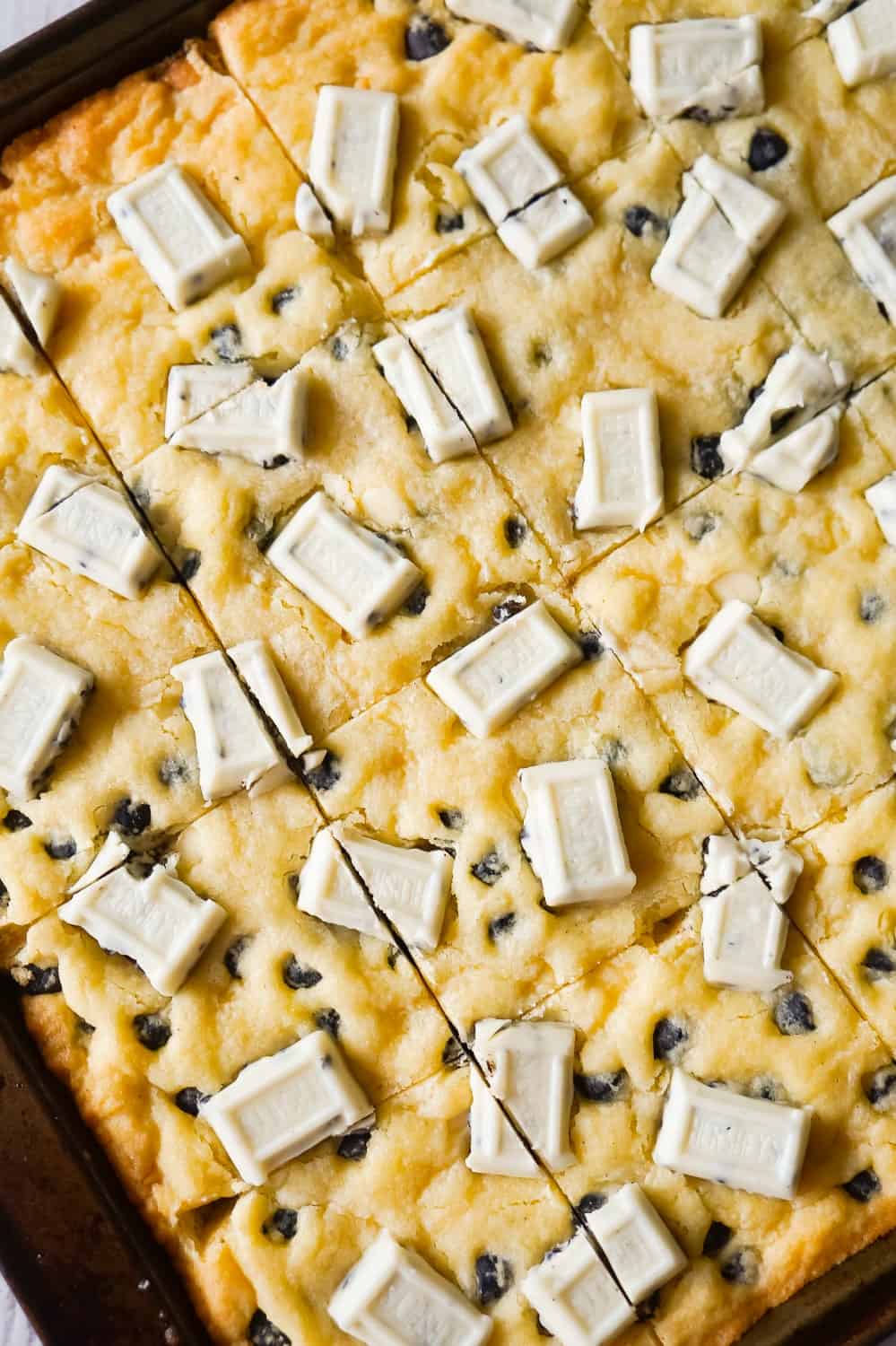 Cookies and Cream Sugar Cookie Bars are chewy sugar cookies made with vanilla pudding mix and loaded with Hershey's Cookies 'n' Creme baking bits and snack size Hershey's Cookies 'n' Creme bars.