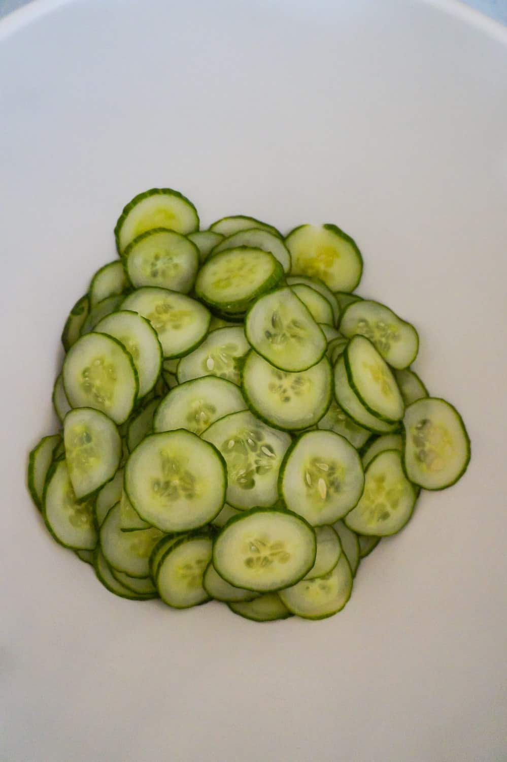 thinly sliced cucumbers in a bowl