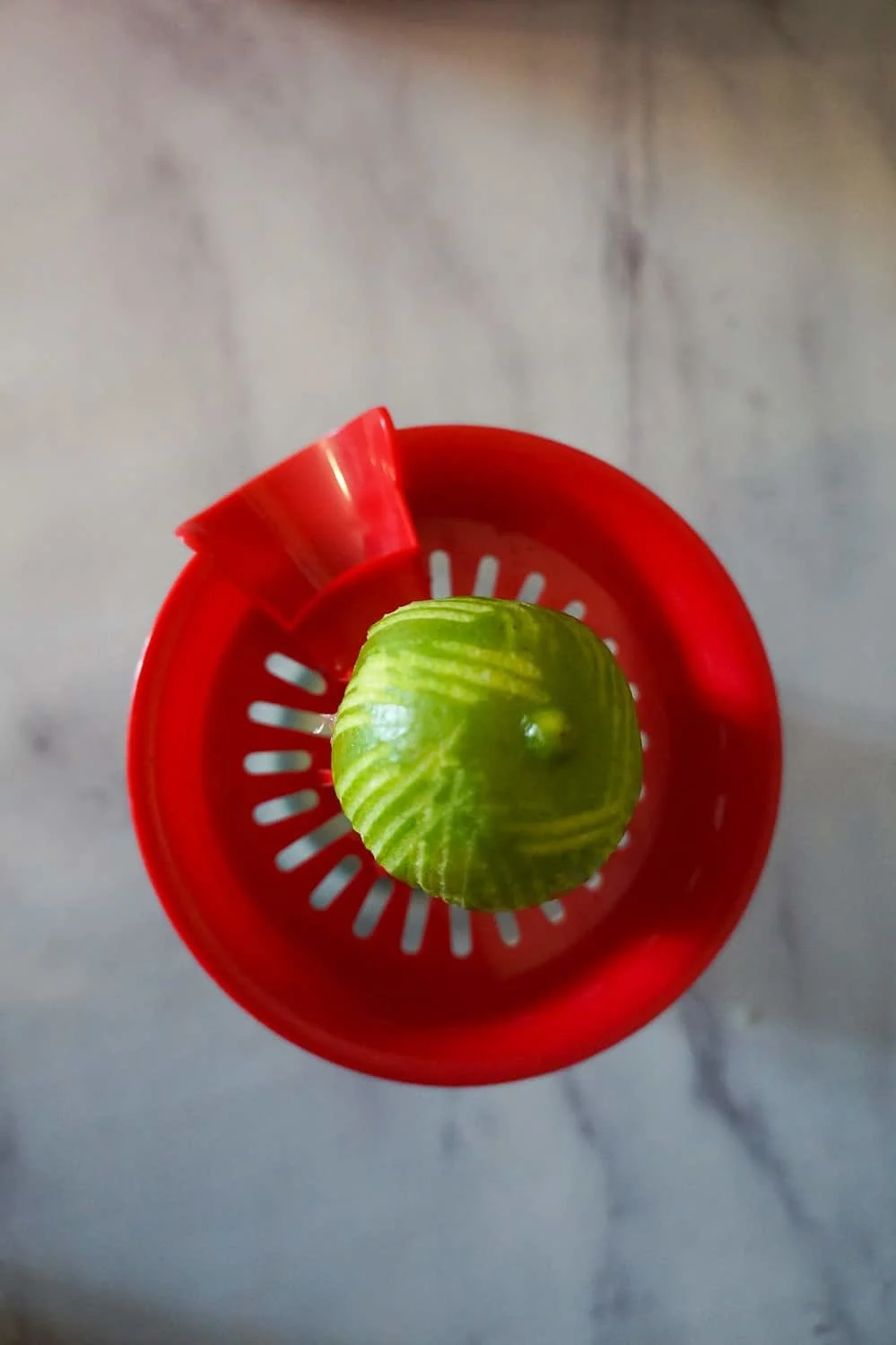 half a lime on top of a juice press