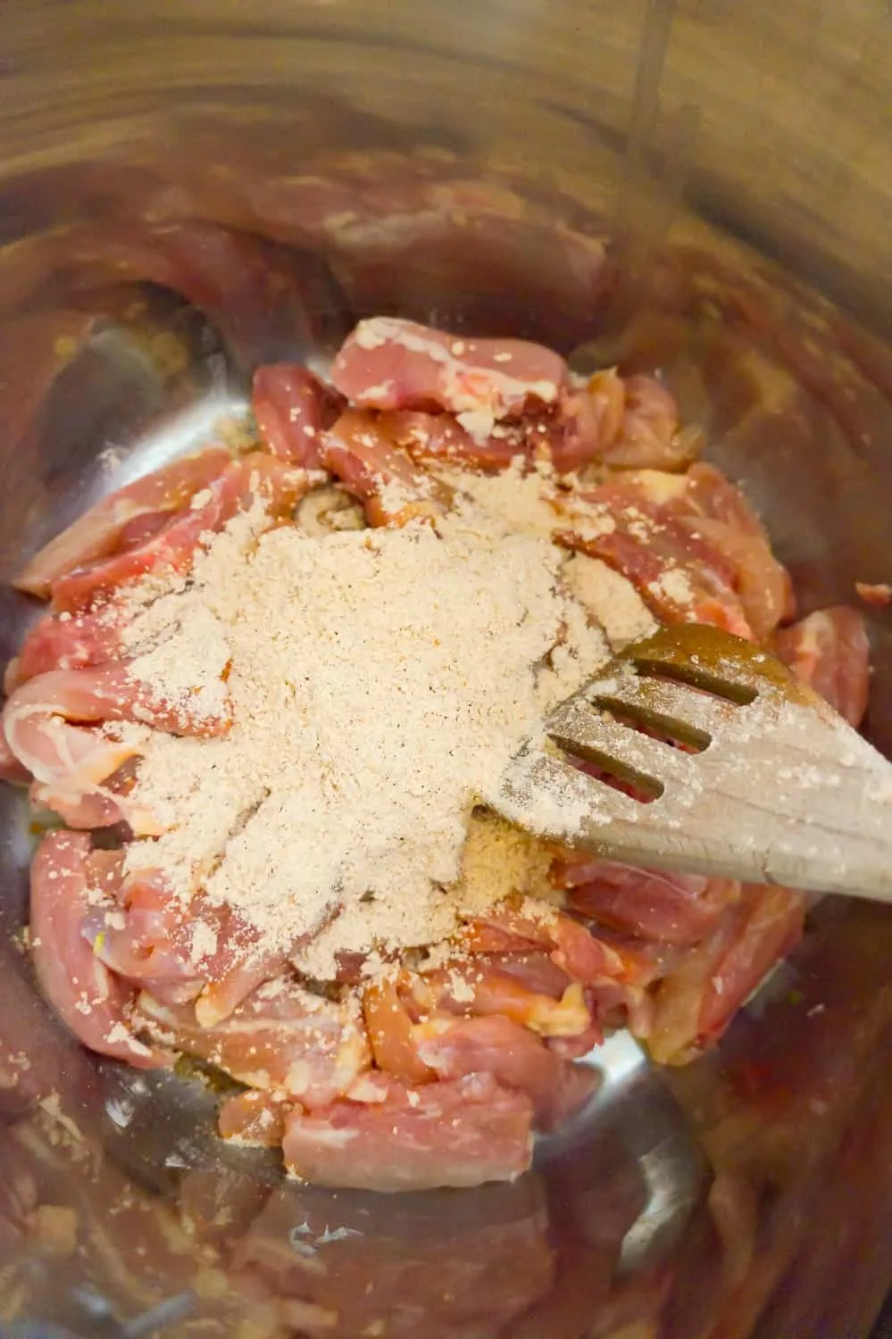 fajita seasoning on top of chicken thigh strips in an Instant Pot