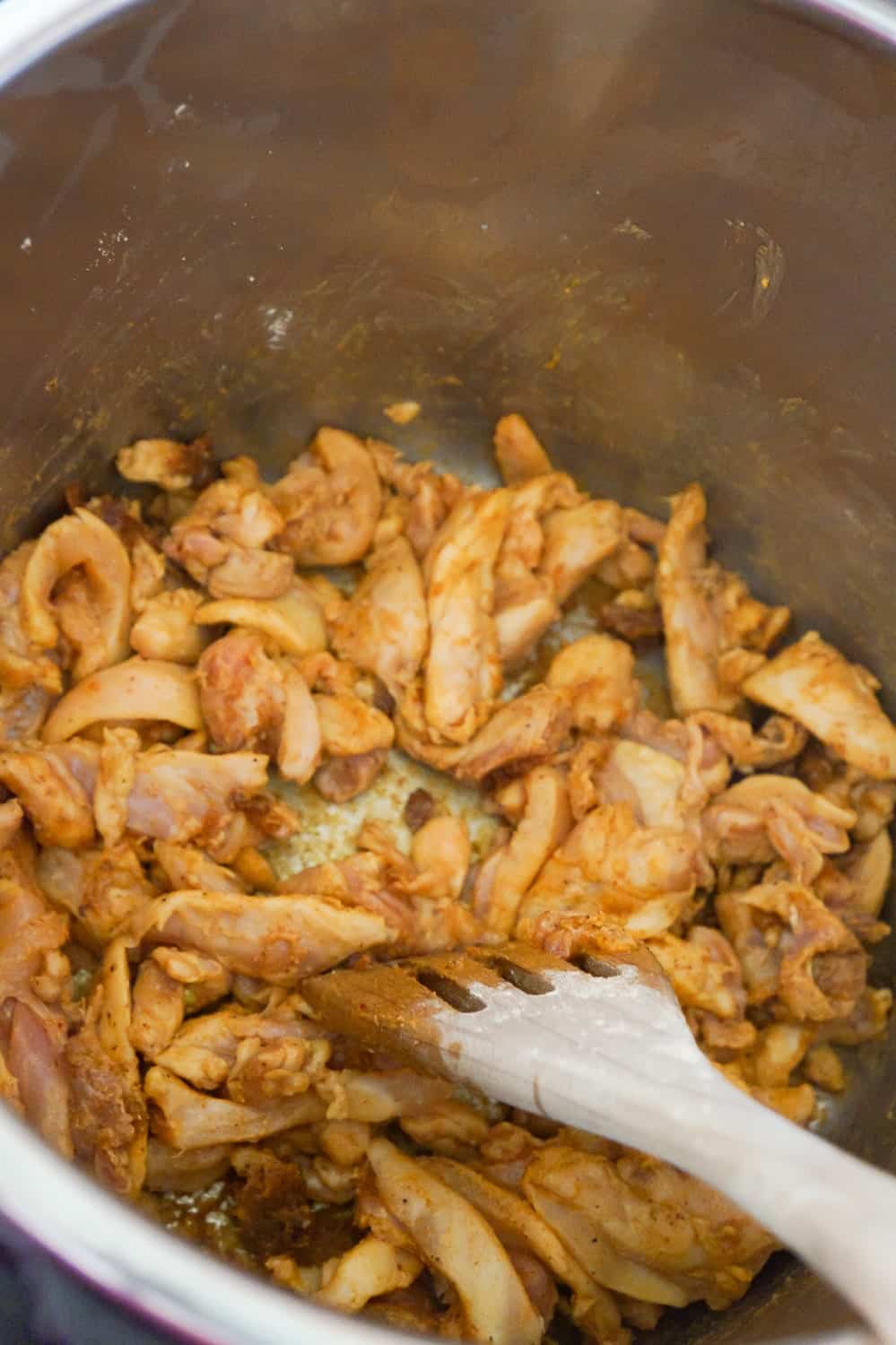 strips of chicken thighs coated in fajita seasoning in an Instant Pot