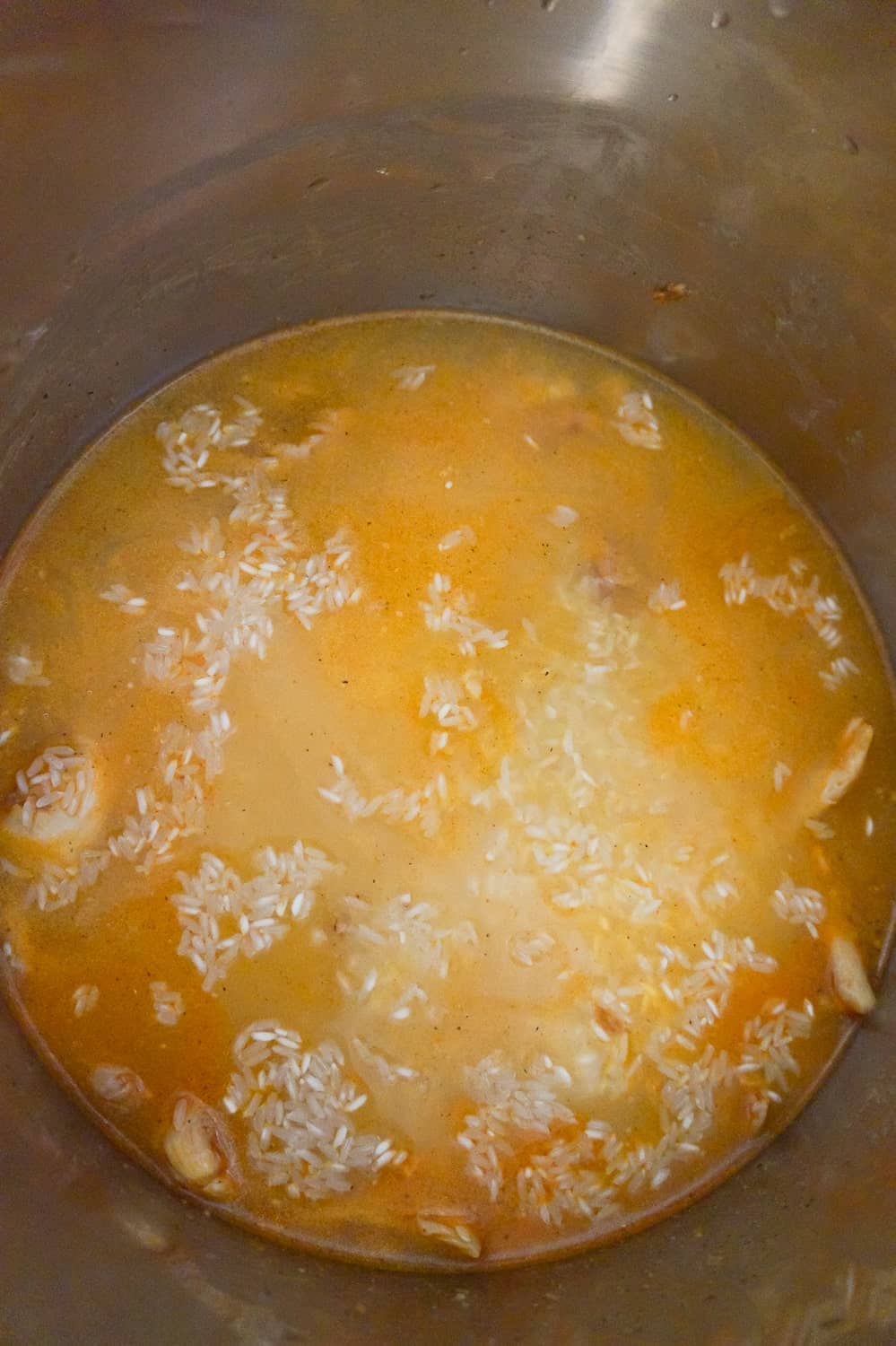 rice and chicken submerged in liquid in an Instant Pot
