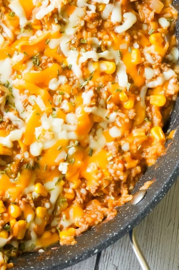 One Pot Mexican Ground Beef and Rice is a stove top dinner recipe loaded with ground beef, rice, salsa, corn and cheese. This cheesy ground beef and rice casserole is an easy dinner recipe perfect for weeknights.