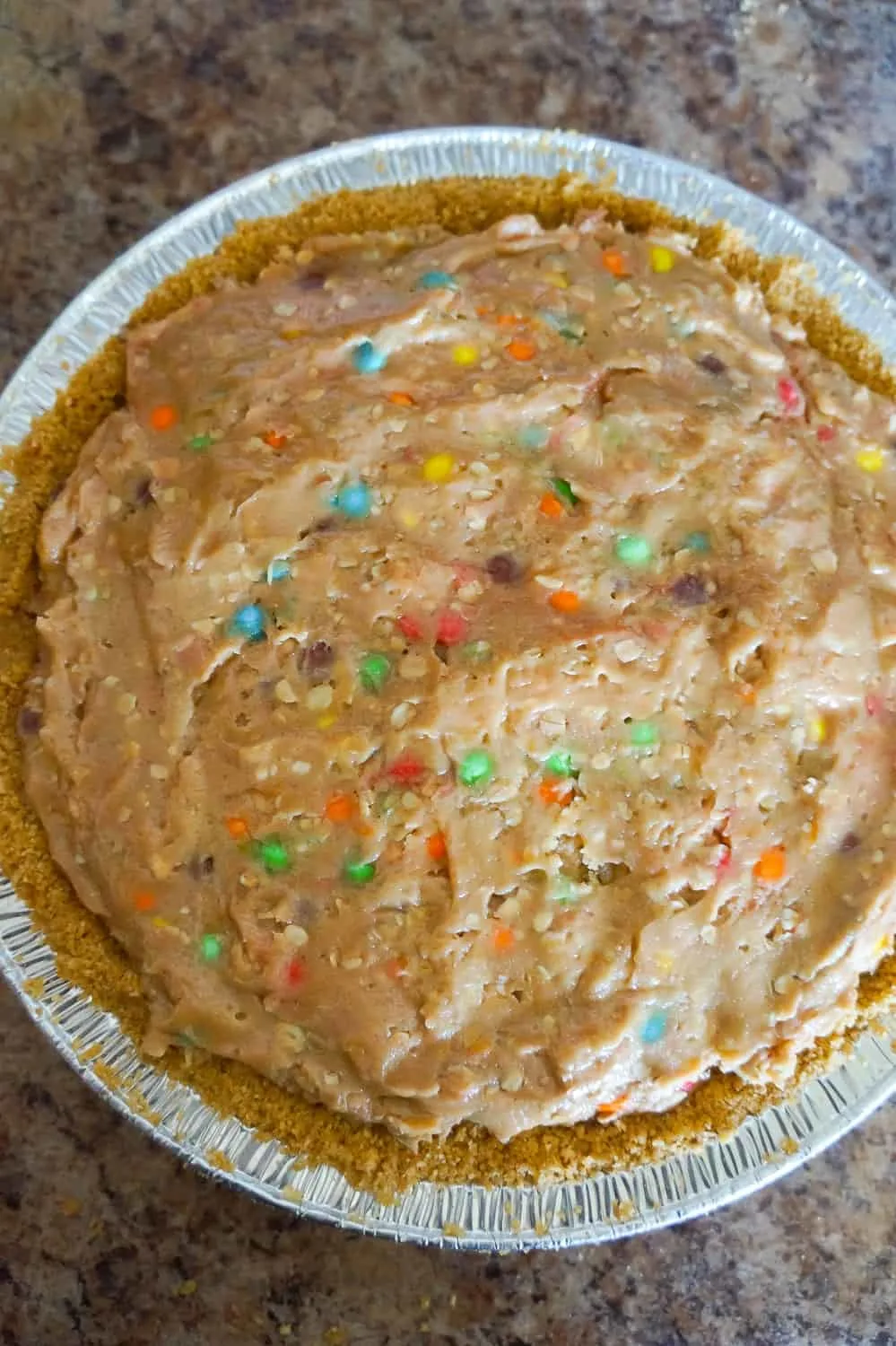 no bake monster cookie dough cheesecake in a graham pie crust