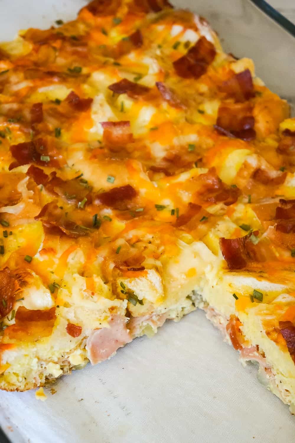 Bagel Breakfast Casserole with Eggs, Ham and Bacon is an easy brunch recipe made with chopped plain bagels loaded with eggs, sliced honey ham and crumbled bacon.