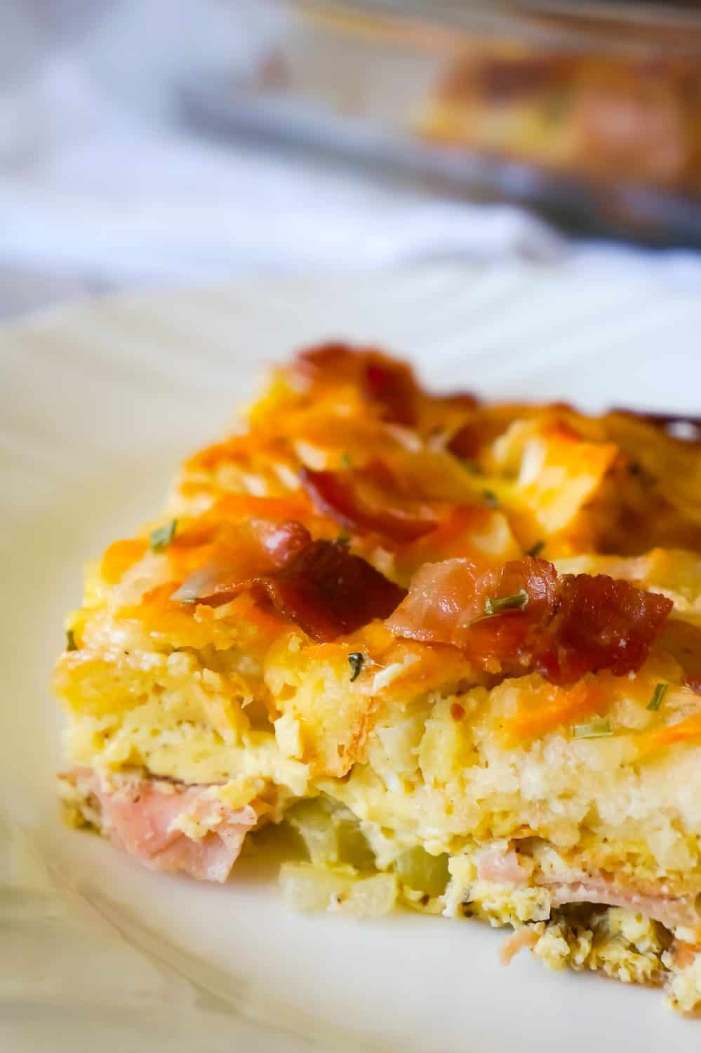 Bagel Breakfast Casserole with Eggs, Ham and Bacon is an easy brunch recipe made with chopped plain bagels loaded with eggs, sliced honey ham and crumbled bacon.