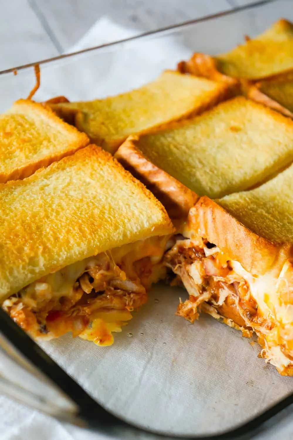 BBQ Chicken Grilled Cheese Casserole is an easy weeknight dinner recipe using shredded rotisserie chicken and loaded with BBQ sauce, bacon, cheddar and mozzarella.