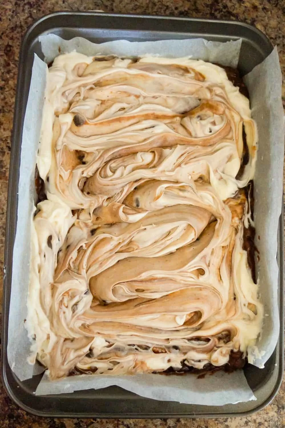 brownies with cream cheese swirl in pan before baking