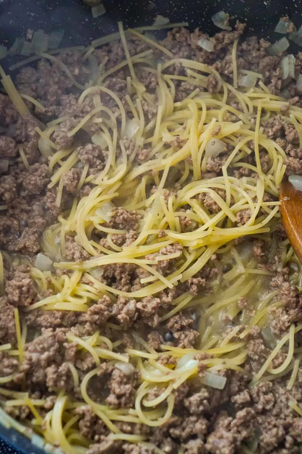 cooked spaghetti and ground beef in a pan