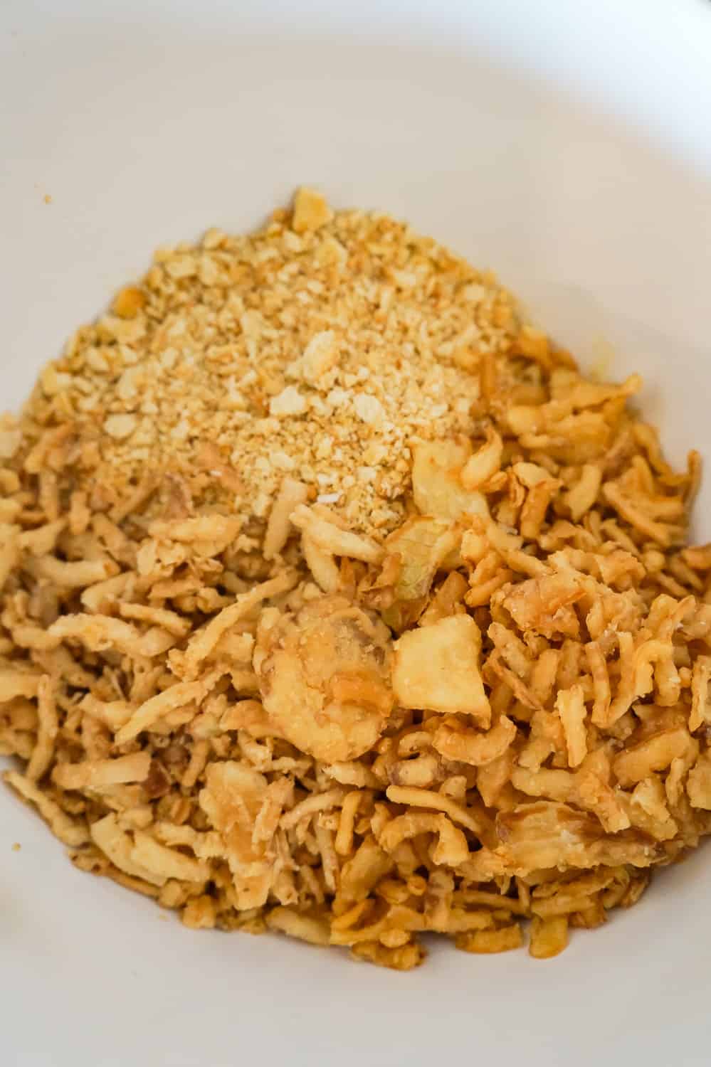 Ritz cracker crumbs and French's fried onions in a mixing bowl.