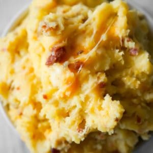 Instant Pot Cheesy Bacon Mashed Potatoes are a delicious pressure cooker side dish recipe using cream of bacon soup, crumbled bacon, cheddar and mozzarella cheese.