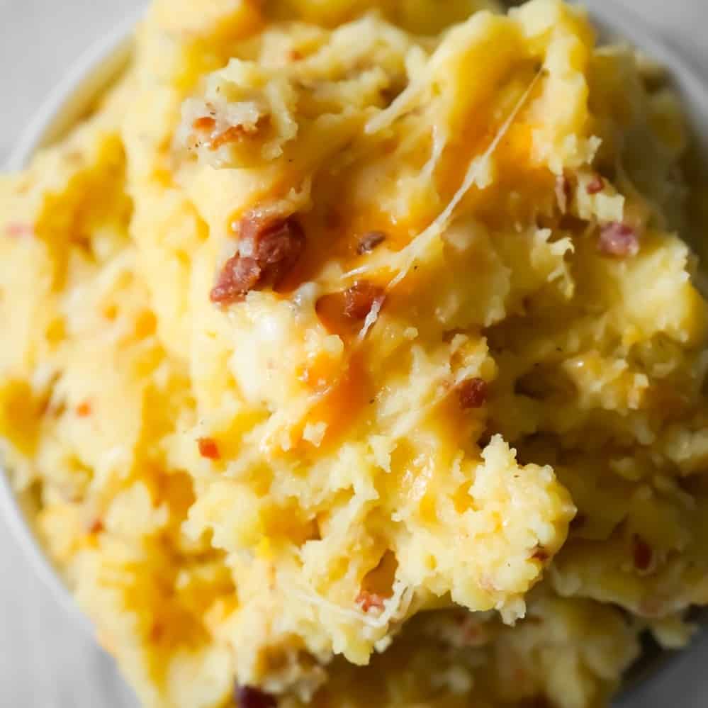 Instant Pot Cheesy Bacon Mashed Potatoes are a delicious pressure cooker side dish recipe using cream of bacon soup, crumbled bacon, cheddar and mozzarella cheese.