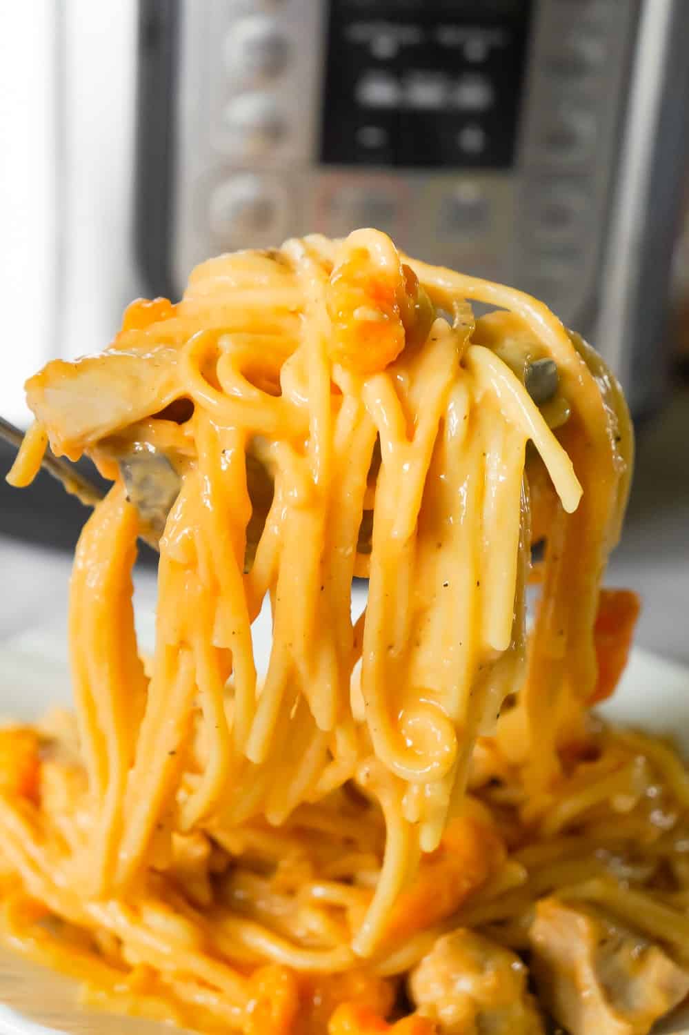 Instant Pot Cheesy Chicken Spaghetti is an easy pressure cooker spaghetti recipe loaded with chicken breast chunks, mozzarella cheese, cheddar cheese and Cheetos.