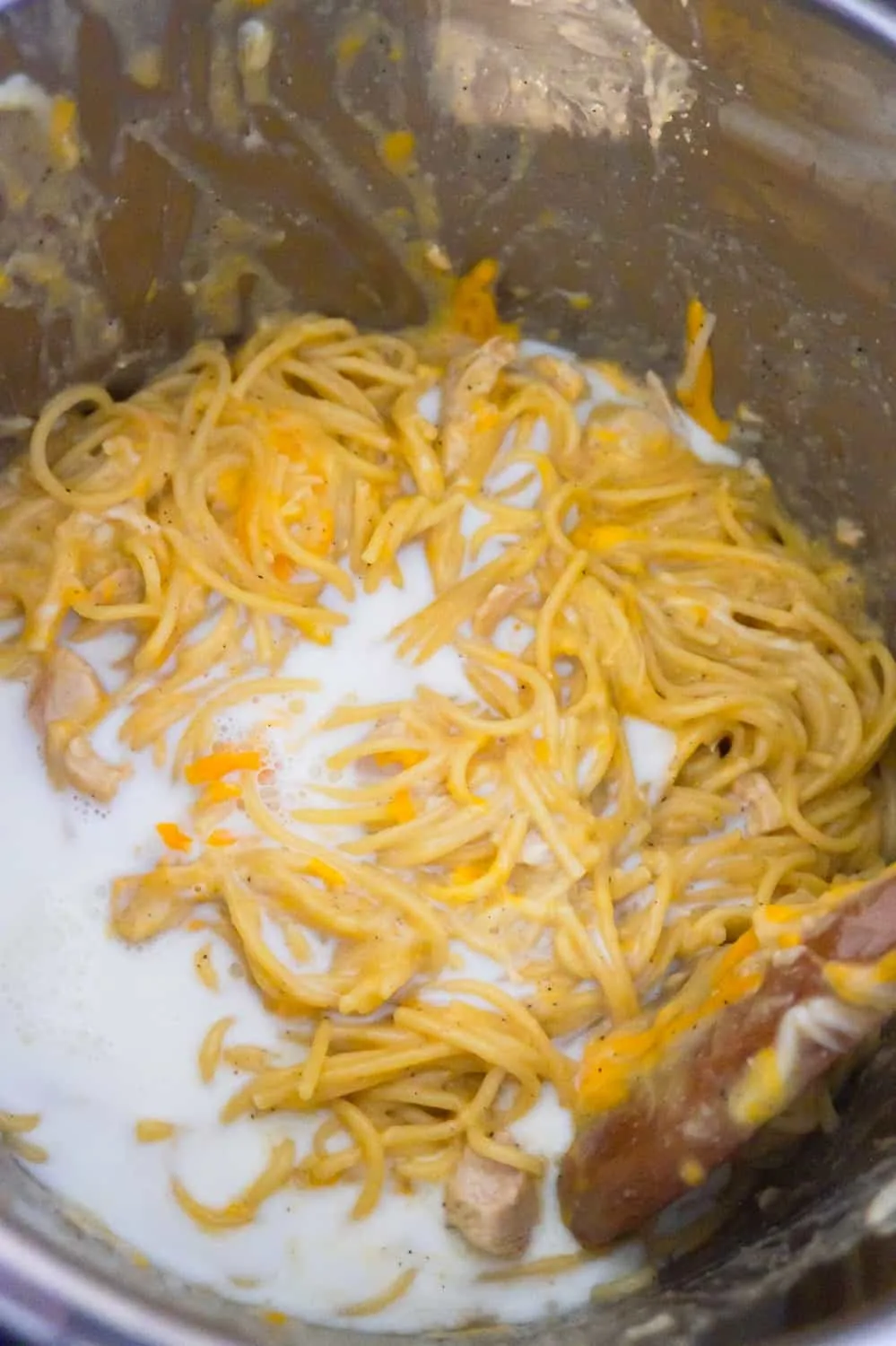 milk poured on top of spaghetti in an Instant Pot