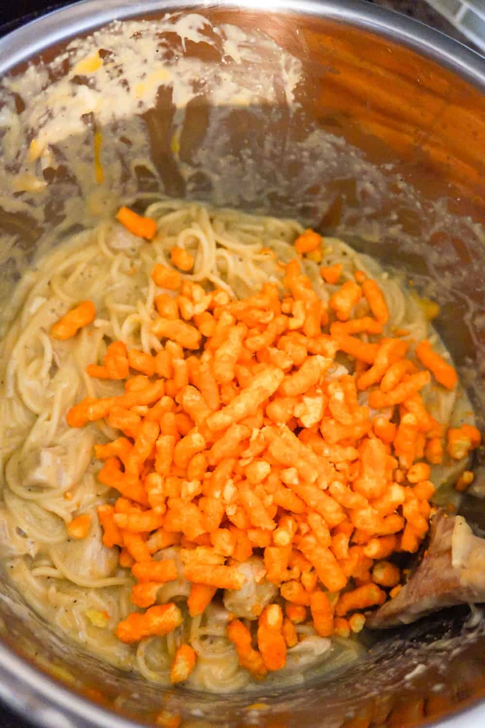cheetos on top of creamy spaghetti in an Instant Pot