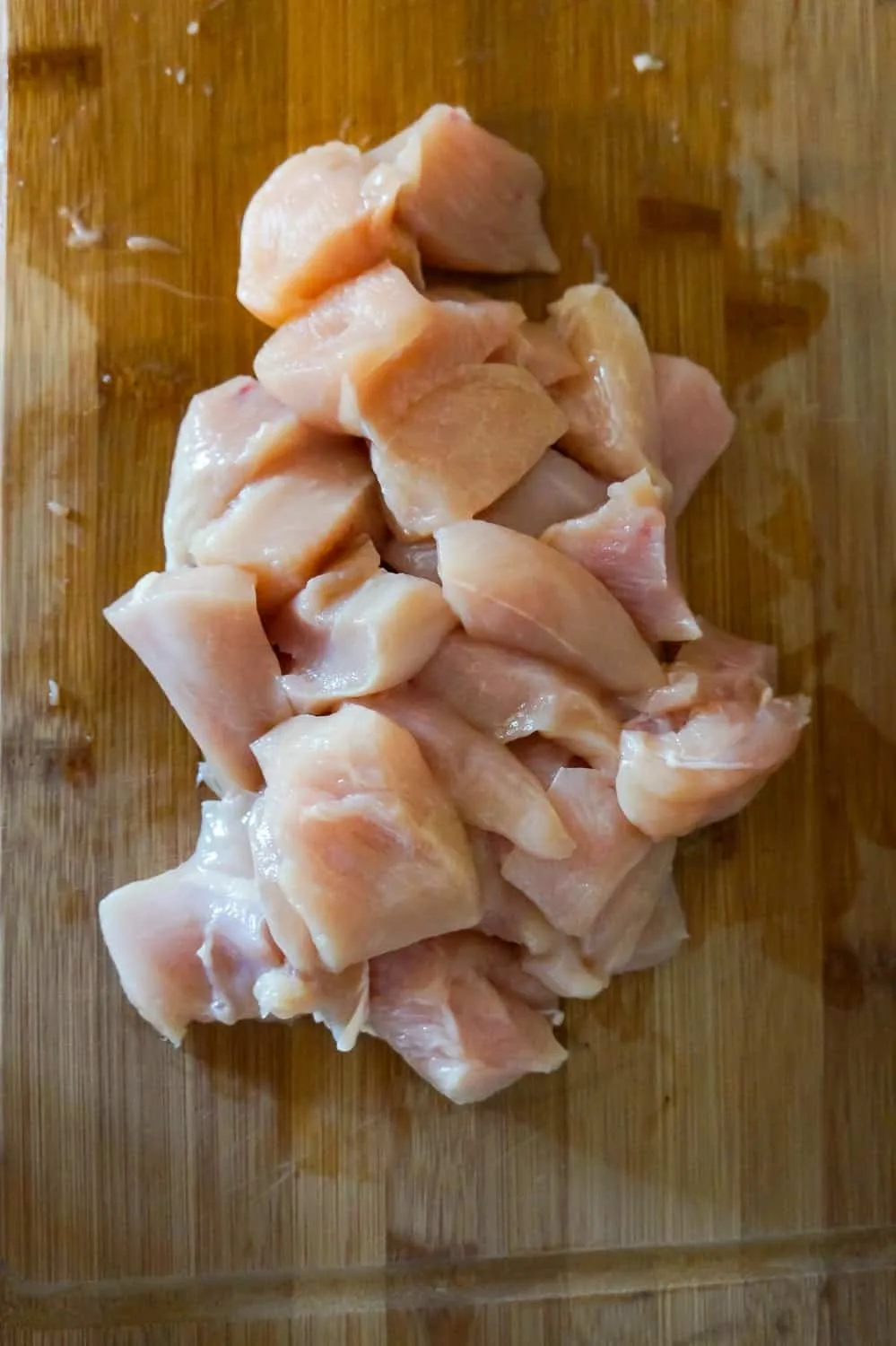 chicken breast chunks on a cutting board