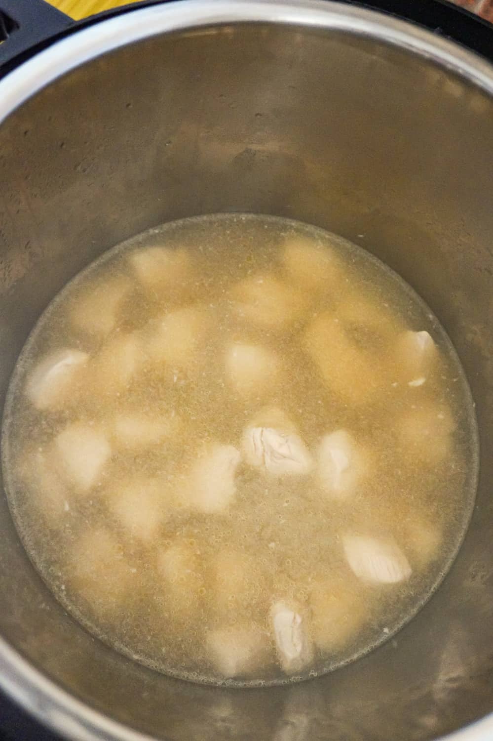 chicken breast chunks in water and chicken broth in an Instant Pot