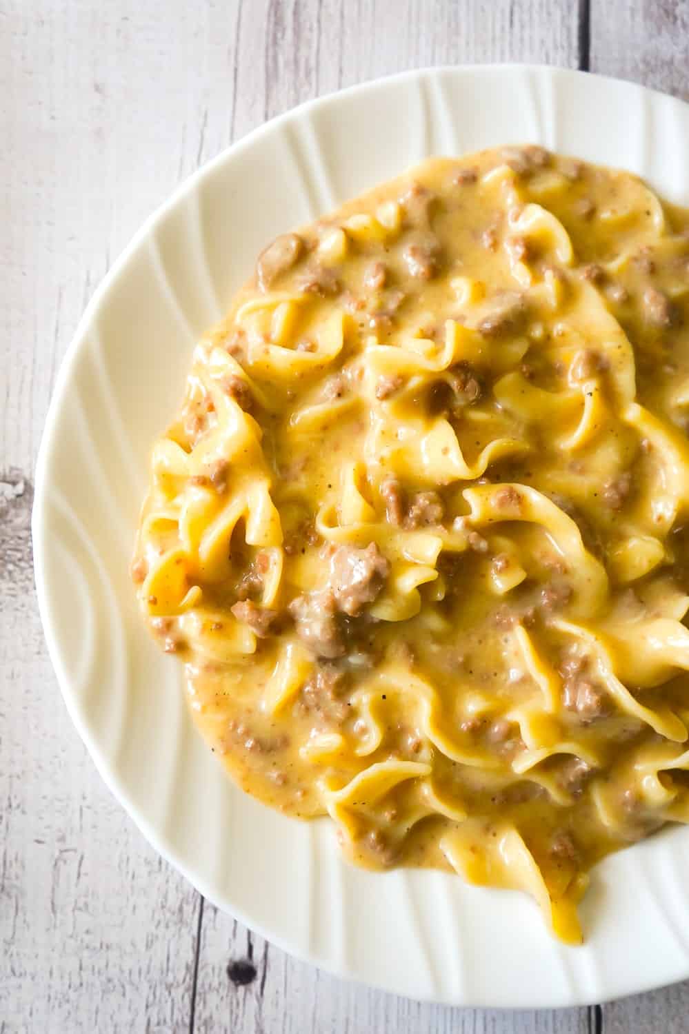 Instant Pot Cheesy Ground Beef and Noodles is an easy pressure cooker dinner recipe using hamburger meat and egg noodles loaded with mozzarella and cheddar cheese.