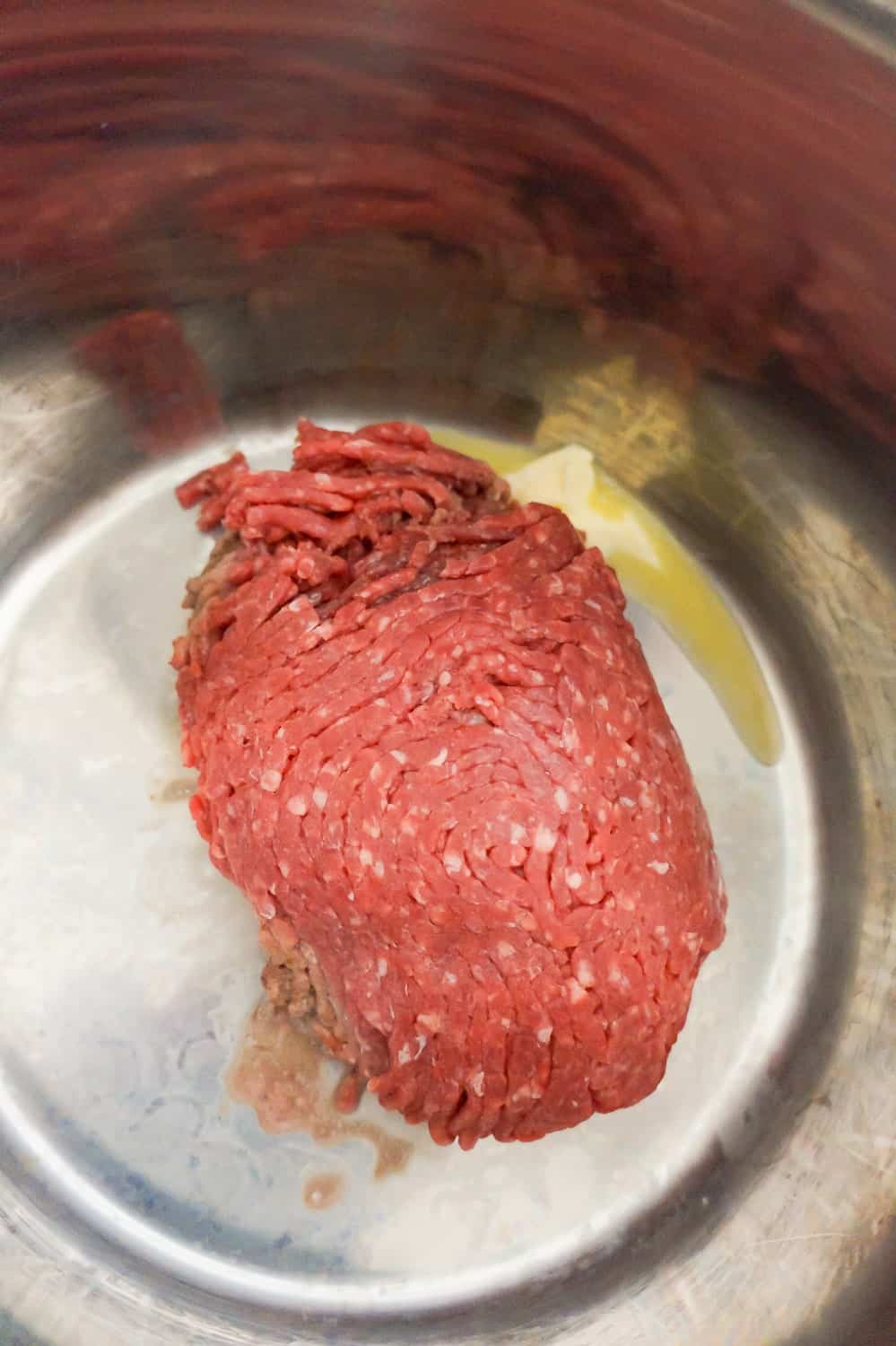 raw lean ground beef in an Instant Pot