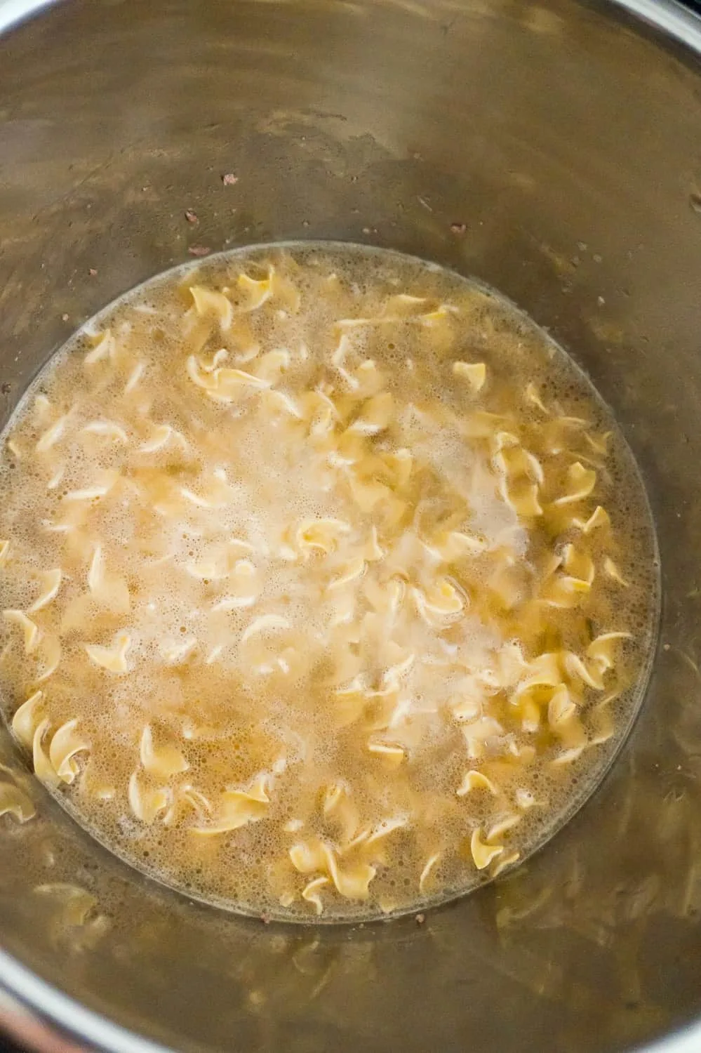 egg noodles submerged in liquid in an Instant Pot