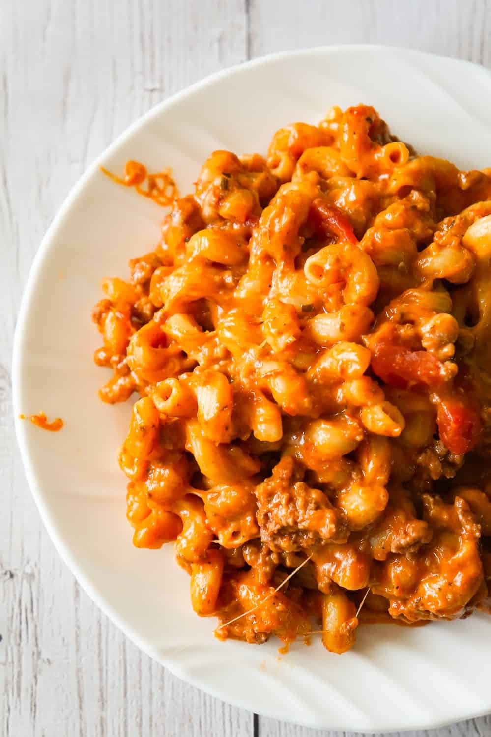 Instant Pot Cheesy Hamburger Macaroni is an easy pressure cooker pasta recipe loaded with ground beef, marinara, cheddar and mozzarella cheese.