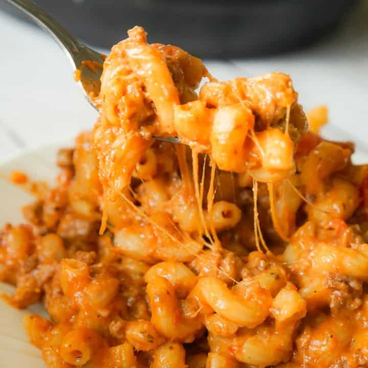 Instant Pot Cheesy Hamburger Macaroni is an easy pressure cooker pasta recipe loaded with ground beef, marinara, cheddar and mozzarella cheese.