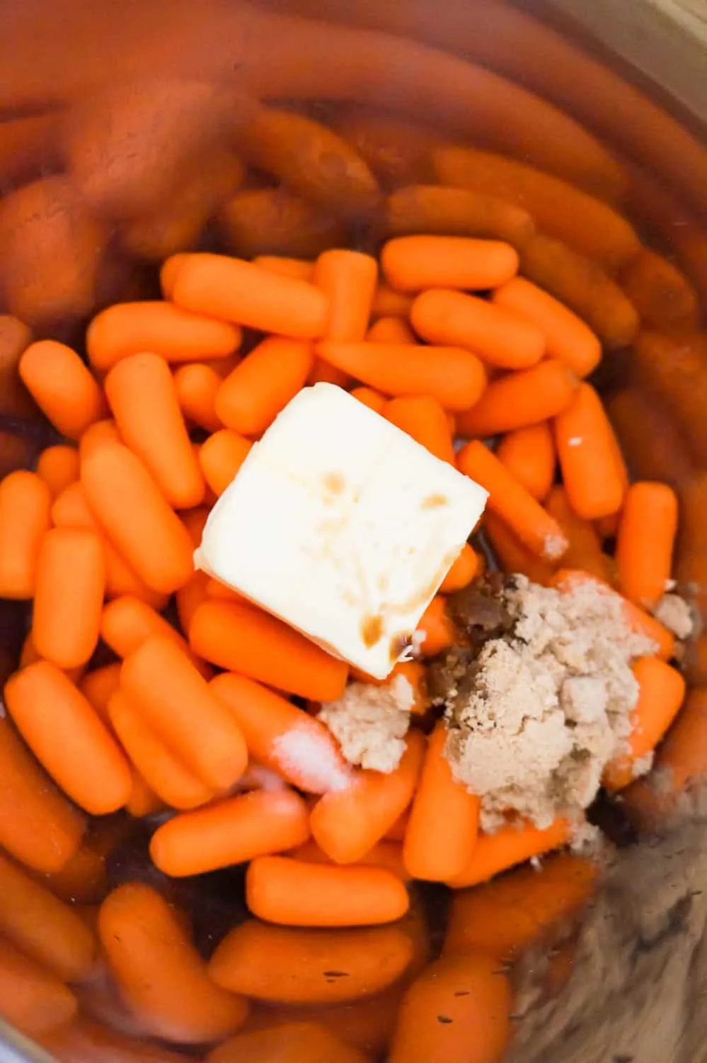 butter, brown sugar and Worcestershire on top of raw baby carrots in an Instant Pot