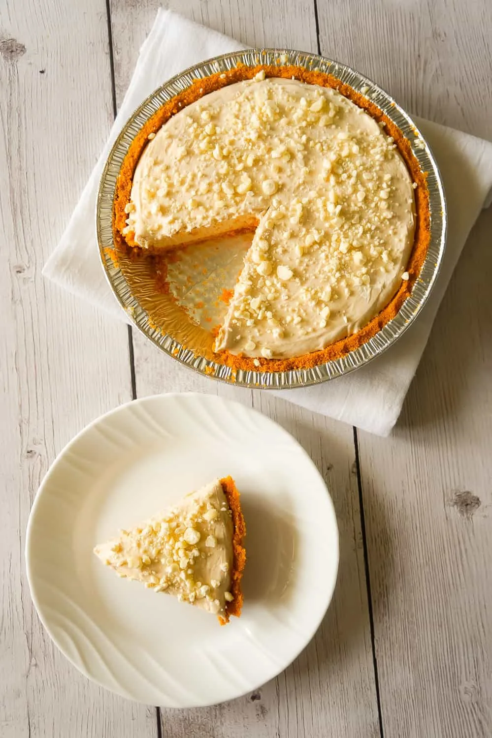 No Bake Pumpkin Spice White Chocolate Cheesecake is an easy fall dessert recipe made with pumpkin pie spice, white chocolate, Cool Whip and a graham cookie pie crust.