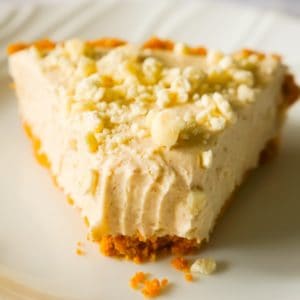 No Bake Pumpkin Spice White Chocolate Cheesecake is an easy fall dessert recipe made with pumpkin pie spice, white chocolate, Cool Whip and a graham cookie pie crust.