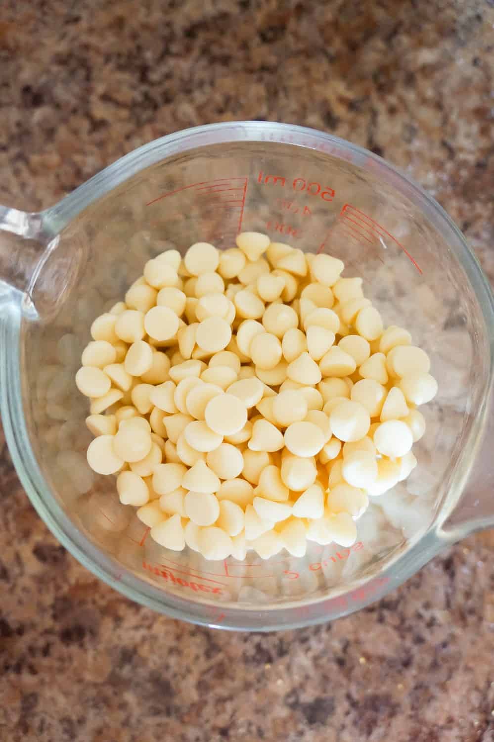 white chocolate baking chips in a glass measuring cup