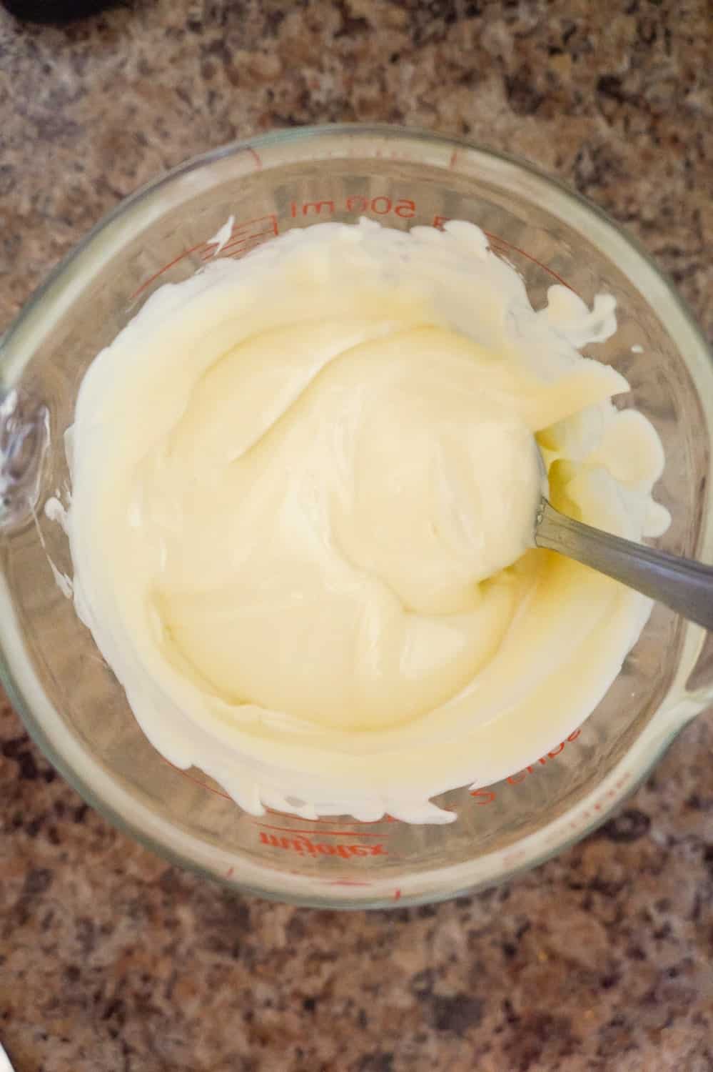 melted white chocolate in a glass measuring cup
