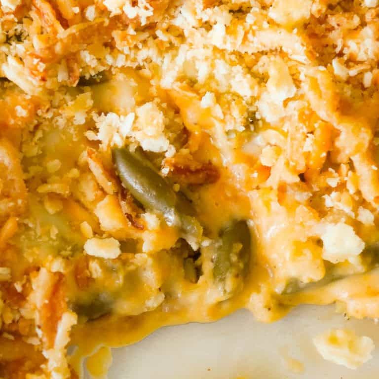 Cheesy Green Bean Casserole is an easy side dish recipe made with Campbell's cheddar cheese soup, shredded Parmesan, mozzarella, cheddar and topped with Townhouse Light and Buttery Original Crackers and French's Fried Onions.