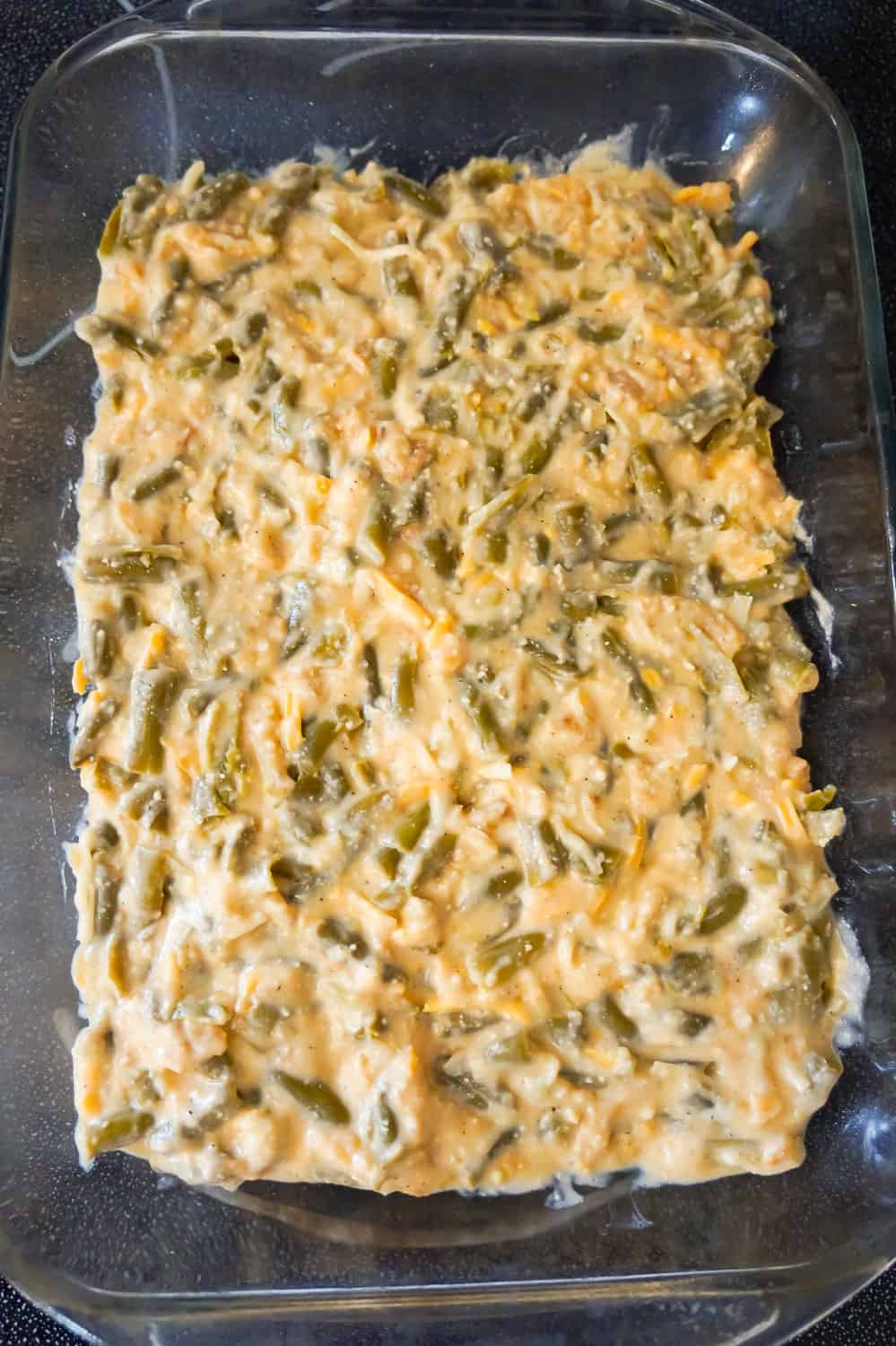 cheesy green bean mixture in a 9 x 13 inch baking dish