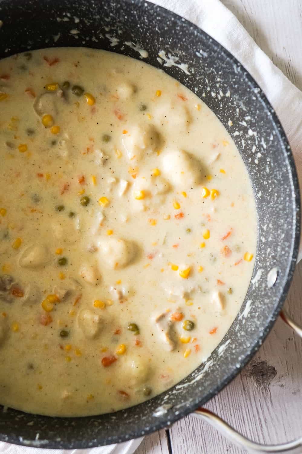 Chicken and Dumplings with Bisquick is a hearty comfort food dish loaded with pieces of chicken, carrots, peas, corn and dumplings made from Bisquick.