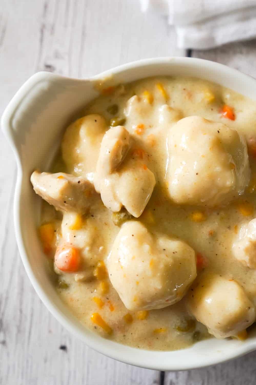 Chicken and Dumplings with Bisquick is a hearty comfort food dish loaded with pieces of chicken, carrots, peas, corn and dumplings made from Bisquick.