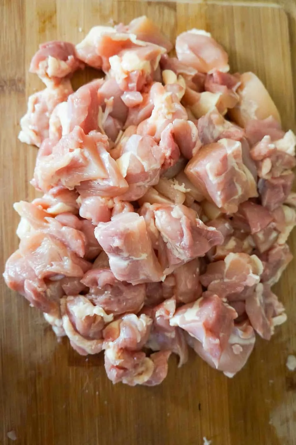 chicken thigh pieces on a cutting board